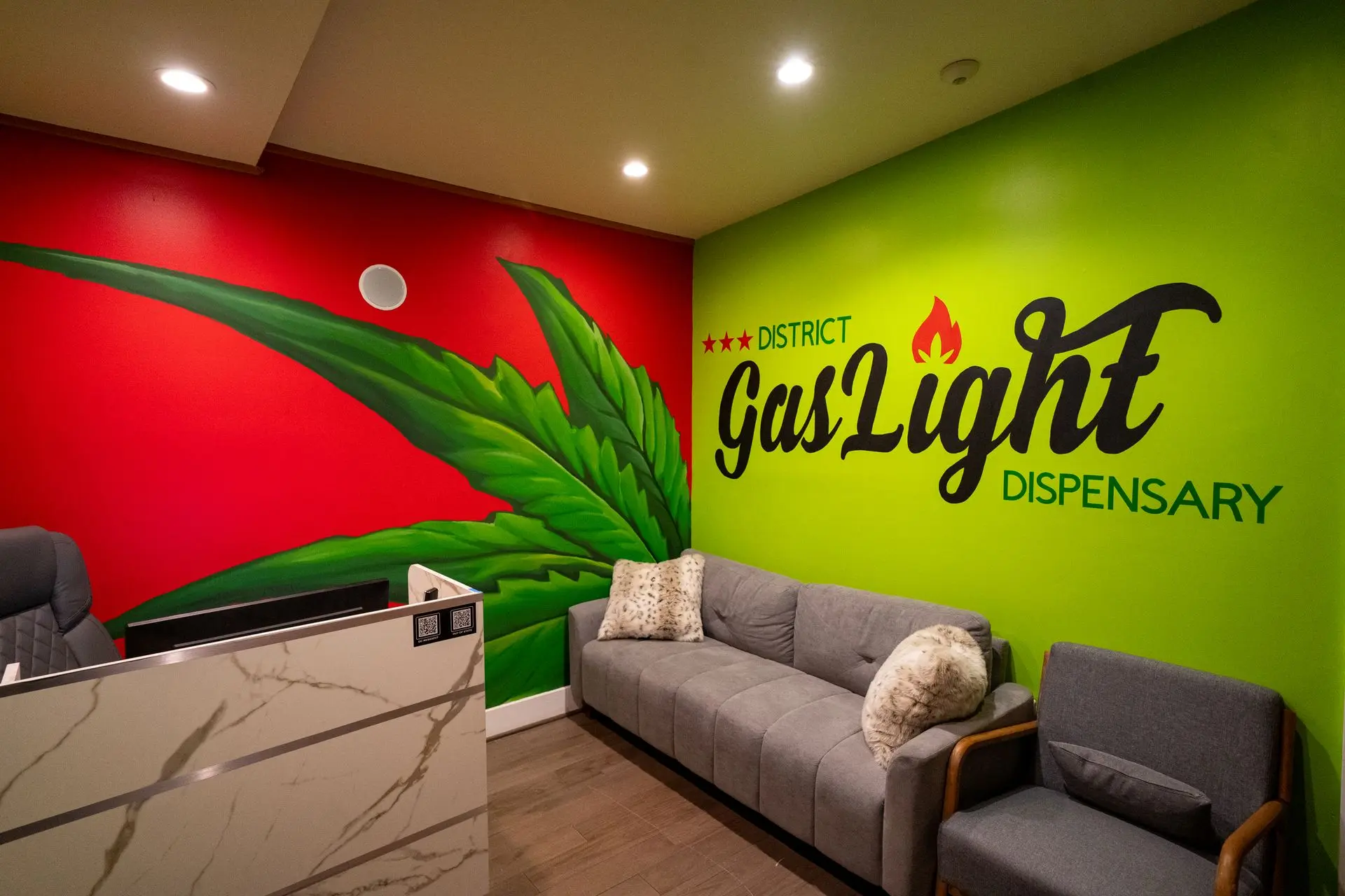 District Gaslight reception lounge with the logo on a lime green wall